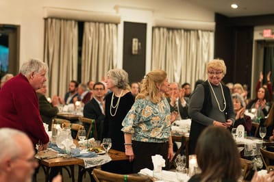 Residents socializing during an event in an elegant dining area
