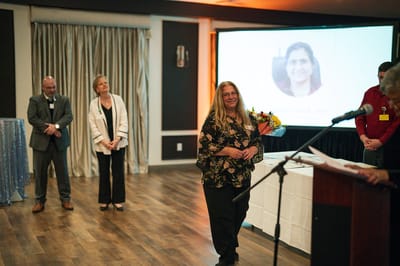 Staff members celebrating an event in a decorated room