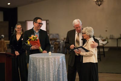 An event with staff and a resident sharing recognition awards