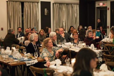 Residents and guests enjoying a social gathering at tables