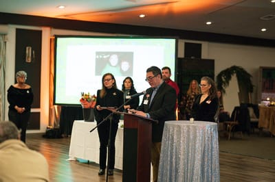 Staff and volunteers at an award event on stage