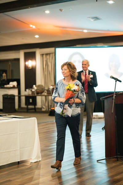 A resident receiving an award at a celebration event
