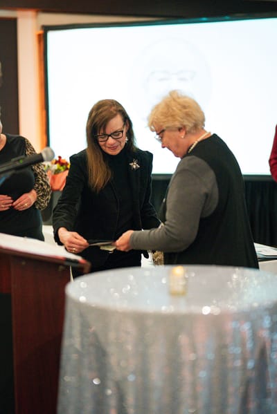 Two women engaged in conversation at an event