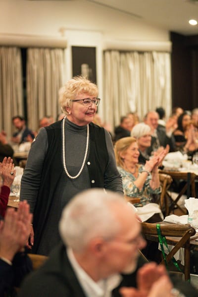 Residents applauding during an event in a community space