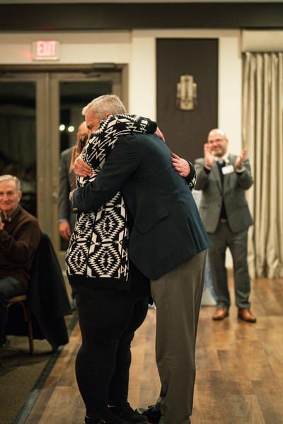 Residents celebrating with hugs in a community event