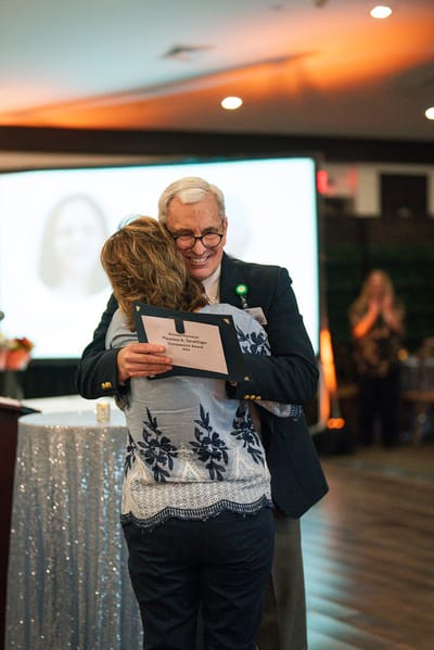 Residents celebrating with awards during an event