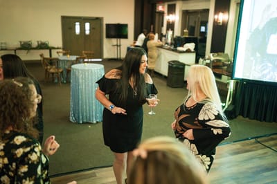 People socializing at a celebration event inside the facility