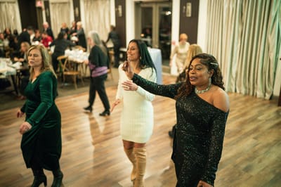 Residents dancing at a festive event in the hall