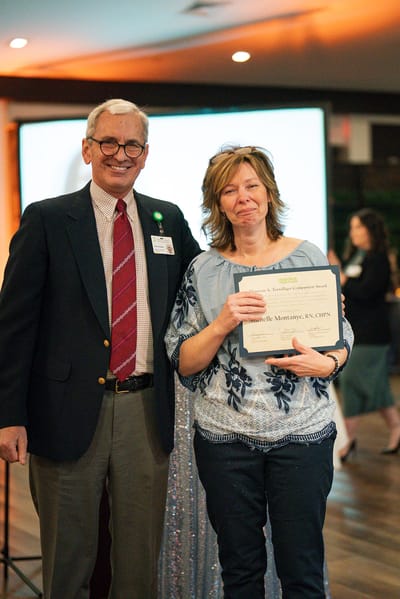 A staff member presenting an award at a ceremony