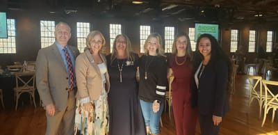 Staff members posing together at an event