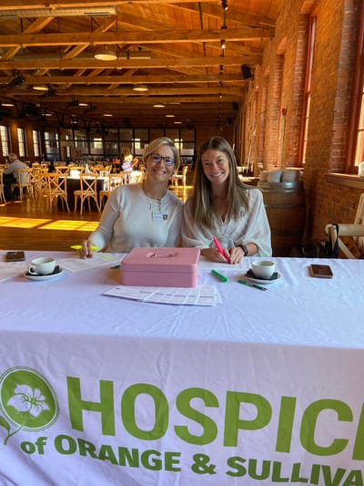 Two staff members engaging with paperwork at a table