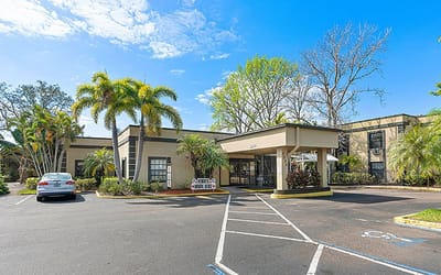 Exterior view of Tierra Pines Center with palm trees