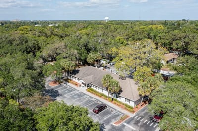 Aerial view of the facility surrounded by greenery