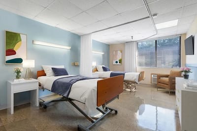A bright, shared resident room with two beds
