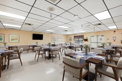 Dining area with tables and chairs set for mealtime