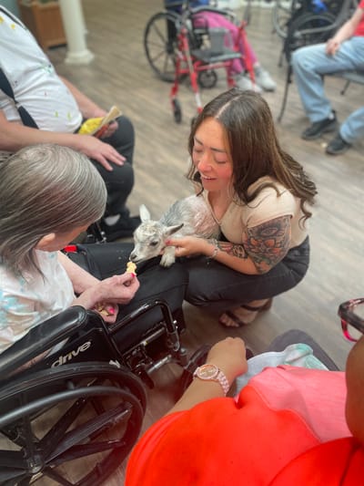 A resident interacting with a pet during activity