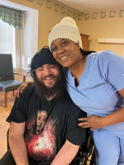 Resident and staff member sharing a joyful moment