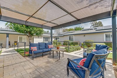 Relaxing outdoor seating area with shaded pergola