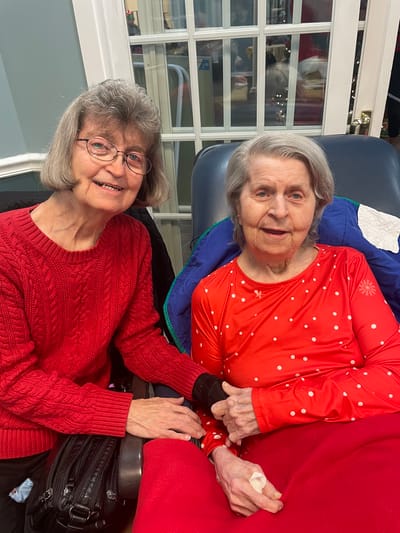 Two residents enjoying time together in a cozy setting