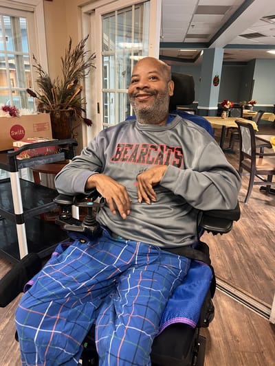 Resident smiling in a common area lounge