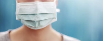 Person wearing a mask in soft focus