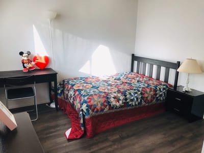 Cozy private room with quilt and lamp