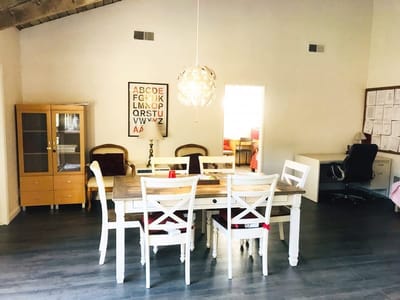 Bright common area with dining table and chairs