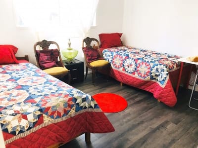 A cozy resident room with two beds and décor