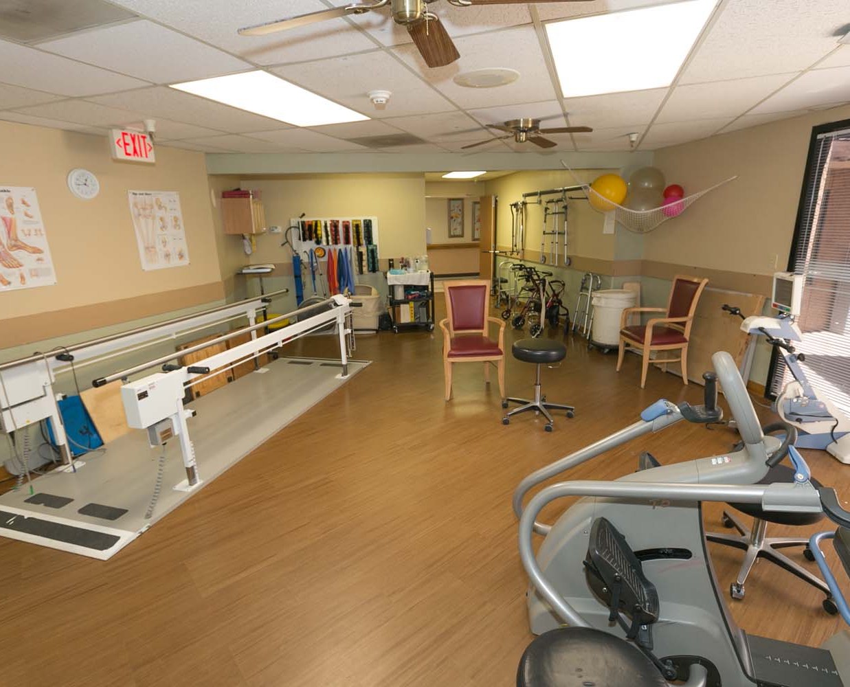Physical therapy room with equipment and exercise tools