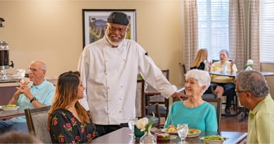 Staff interacting with residents in a dining area