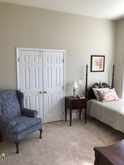 Cozy private room with a bed and chair