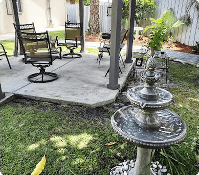 Outdoor seating area with a fountain and greenery