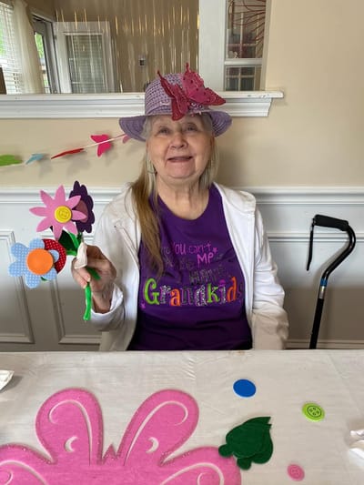 Resident engaged in crafting activity with flowers