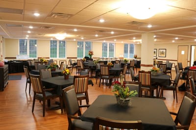 Dining area with tables and floral arrangements