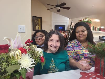Residents and staff celebrating in a decorated common area