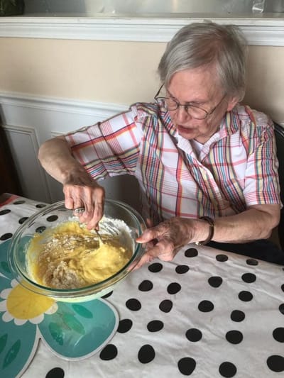 Senior resident mixing batter in a bowl