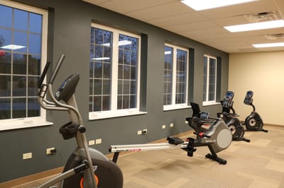Fitness equipment in a well-lit exercise room