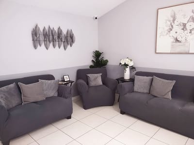 A cozy seating area with grey couches and decor