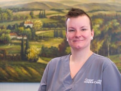 Smiling staff member in a care facility interior