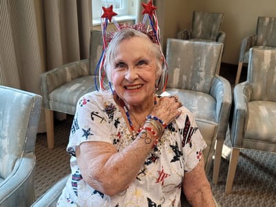 Resident celebrating with festive accessories in common area