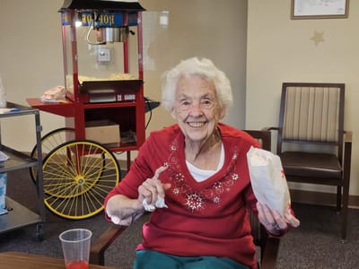 Smiling resident enjoying popcorn in a common area