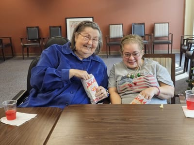 Two residents enjoying snacks in a common area