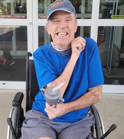 Resident enjoying time outside with a drink