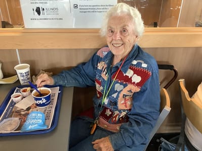 Elderly resident enjoying a meal in the dining area