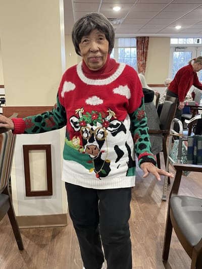 Resident wearing a festive sweater in a common area