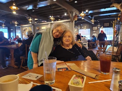 Two residents enjoying a warm moment in a social space