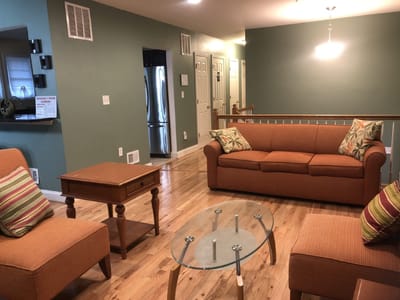 Cozy living room area with orange sofa and coffee table