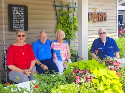 Residents enjoying time together on a porch swing