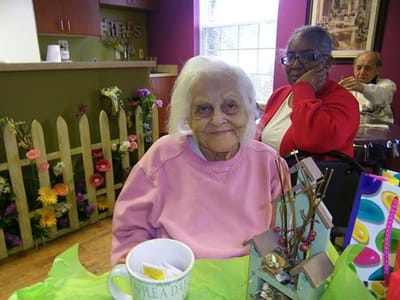Resident smiling in a bright interior space