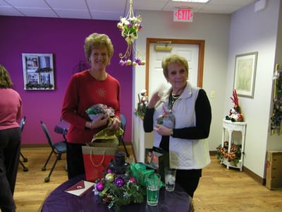 Residents celebrating with gifts in a colorful activity room